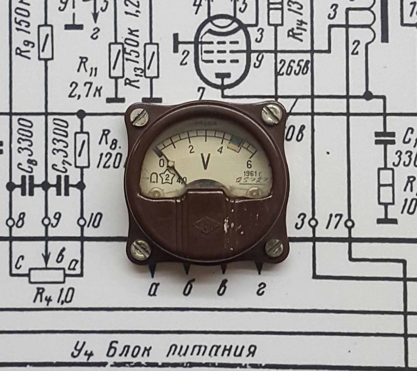 Figure 3 — 3 — A small analog panel voltmeter with a shallow ~90° arc scale and rear screw terminals — the cheap, easily re-faced class the owner's two-meter build uses (this one a vintage 0–6 V unit…
