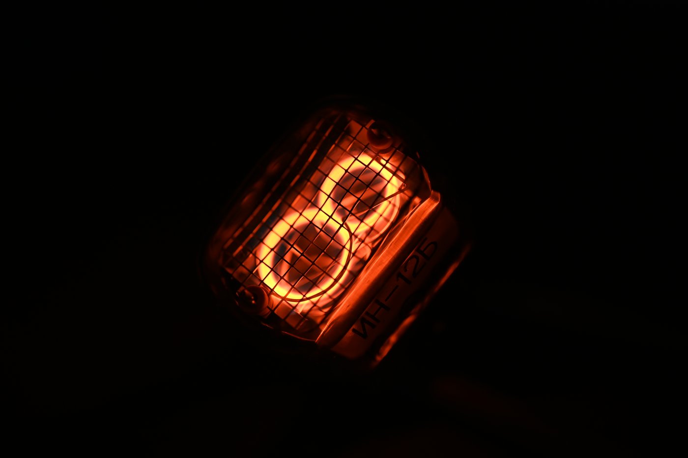 Figure 6 — 7 — An IN-12 tube, the common end-view Soviet type: the numeral stack is read down the axis of the tube rather than through its side, which suits flat PCB-mounted clocks. Photo: File:IN-12…